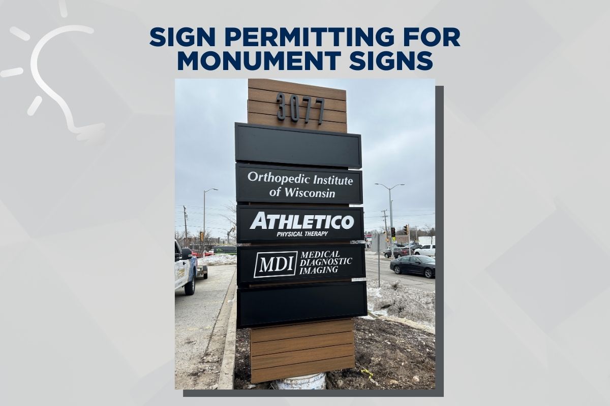 Monument Sign Permitting Process - Image shows a monument sign with a composite wood backing with multiple store signs stacked vertically on top of one another