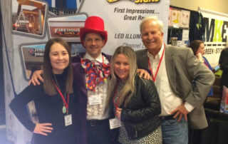 Employees standing in front of a tradeshow booth