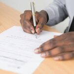 A businessperson signs a permit.