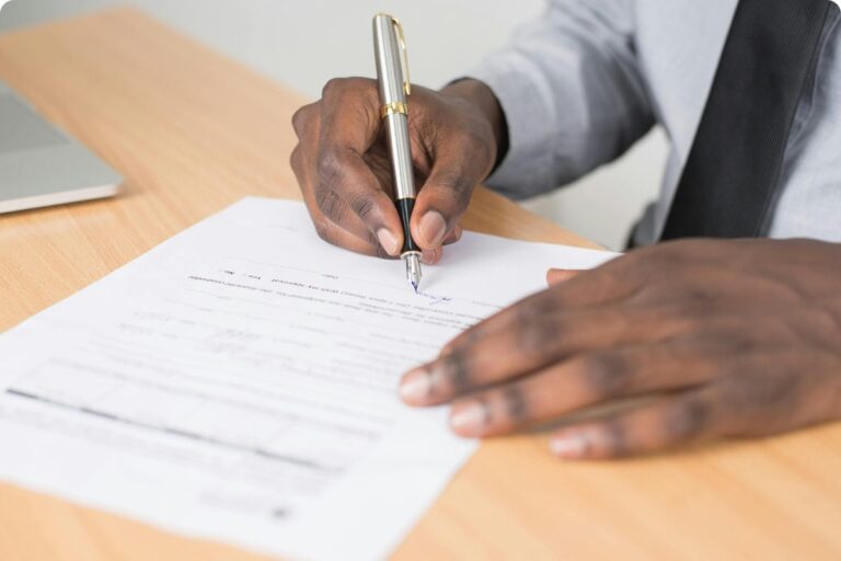 A businessperson signs a permit.