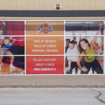 Custom printed signage on front windows for a Crunch Fitness.
