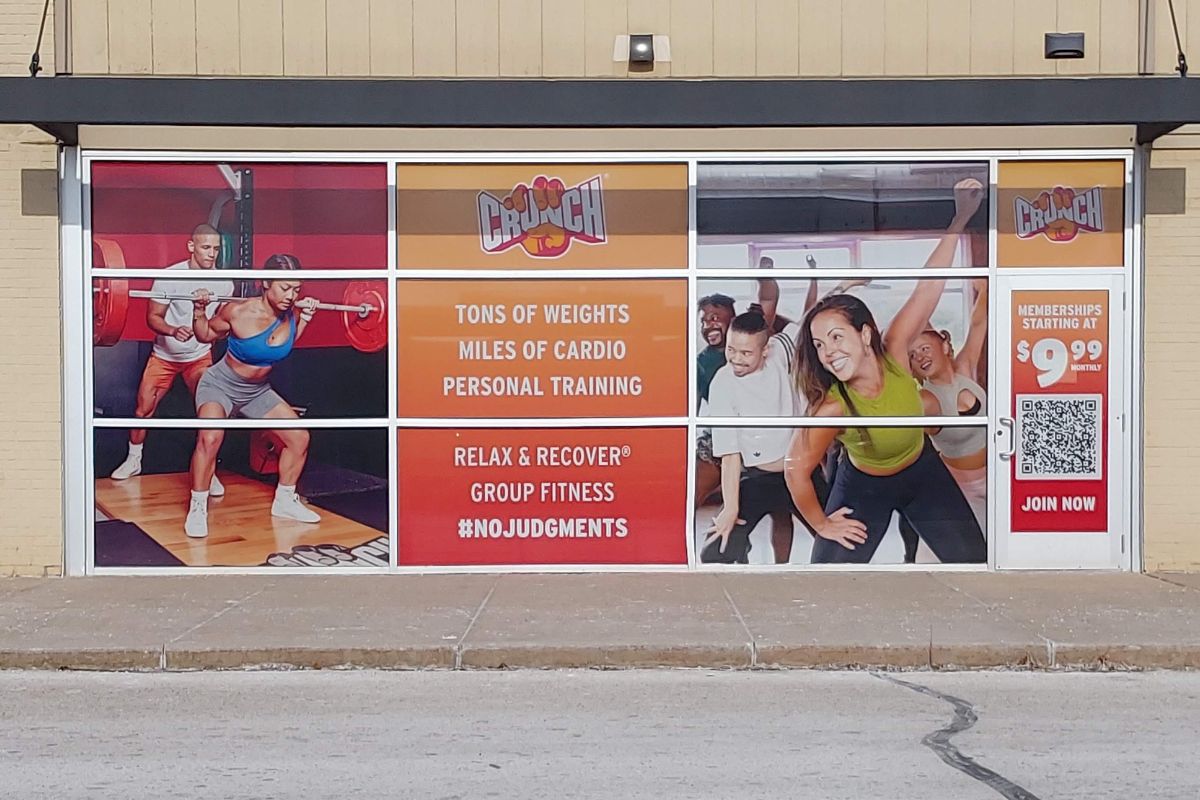 Custom printed signage on front windows for a Crunch Fitness.
