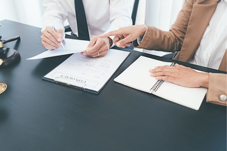 Two people discussing a contract.