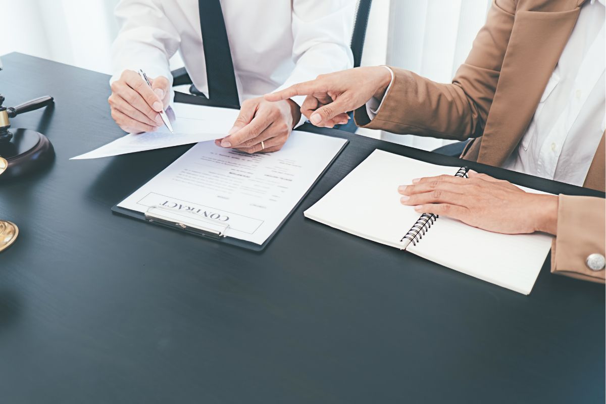 Two people discussing a contract.